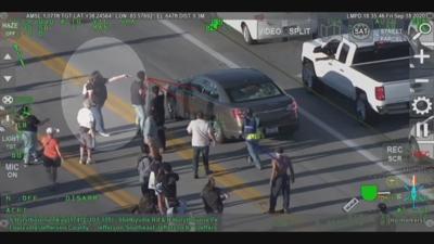 WOMAN POINTS GUN DURING FRIDAY PROTESTS 9-19-20.jpeg