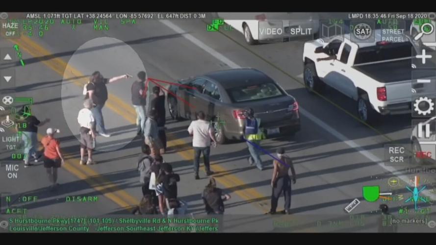 WOMAN POINTS GUN DURING FRIDAY PROTESTS 9-19-20.jpeg