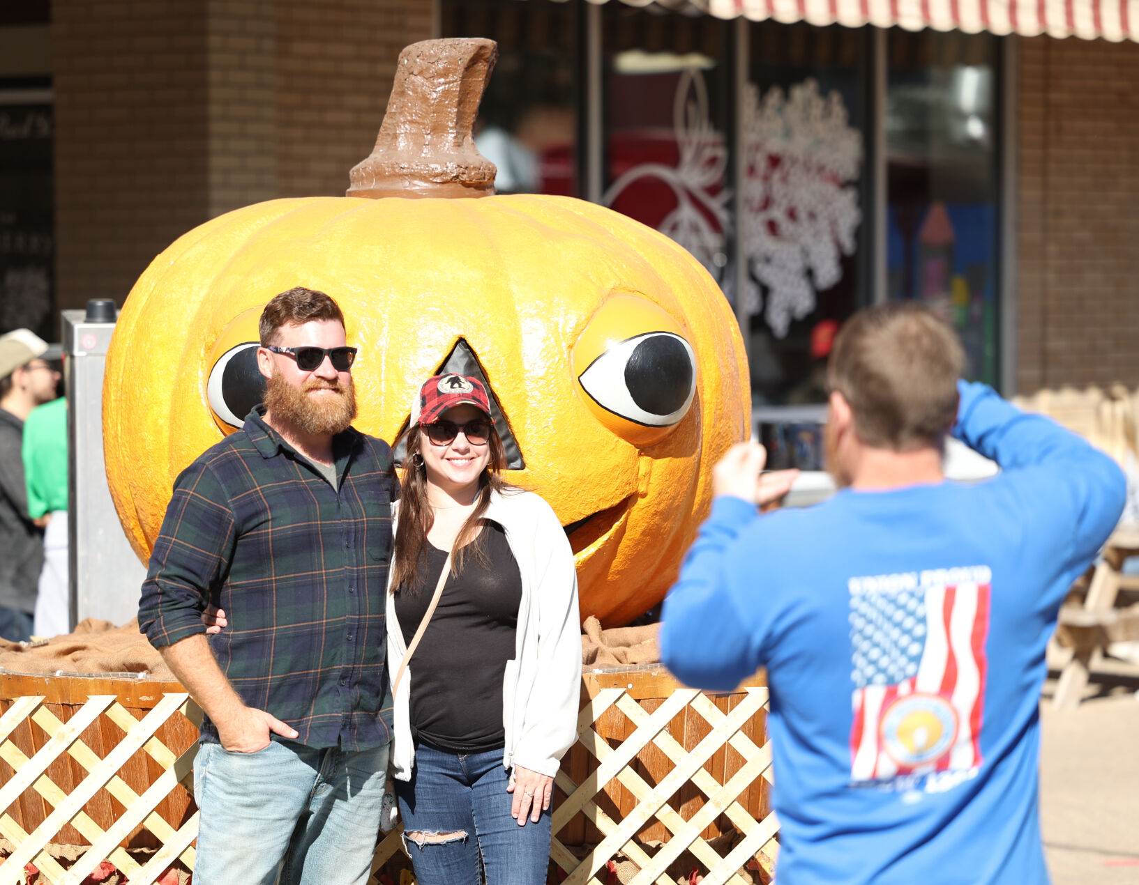 Harvest Homecoming - People take photo with pumpkin.JPG