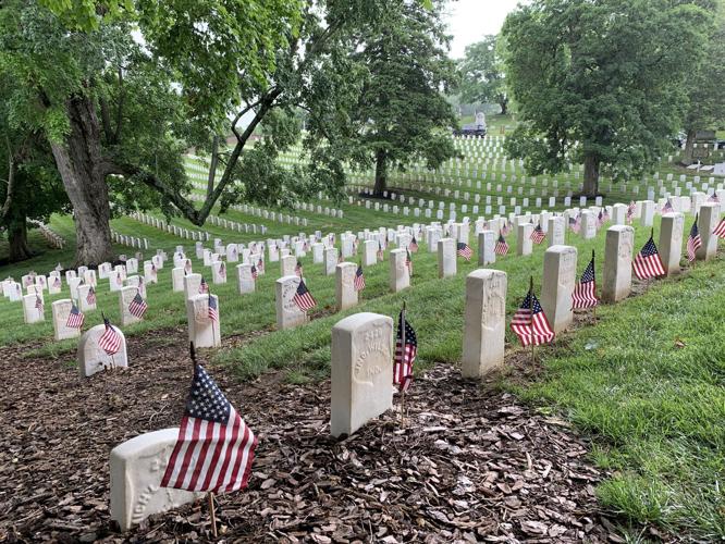 Flags placed on the graves of veterans at Cave Hill Cemetery on Friday, May 27, 2022