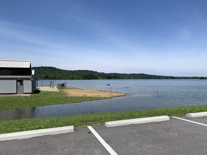 Water covers the beach and a parking lot at Patoka Lake