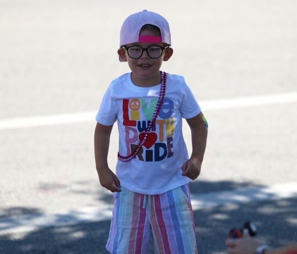 Child stands at Kentuckiana Pride Parade