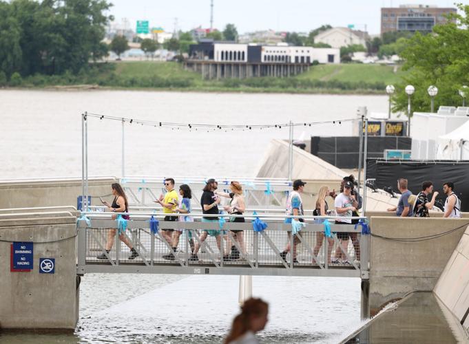 People walk across the bridge at Forecastle.JPG