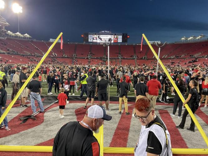 Fans storm the field at Cardinal Stadium