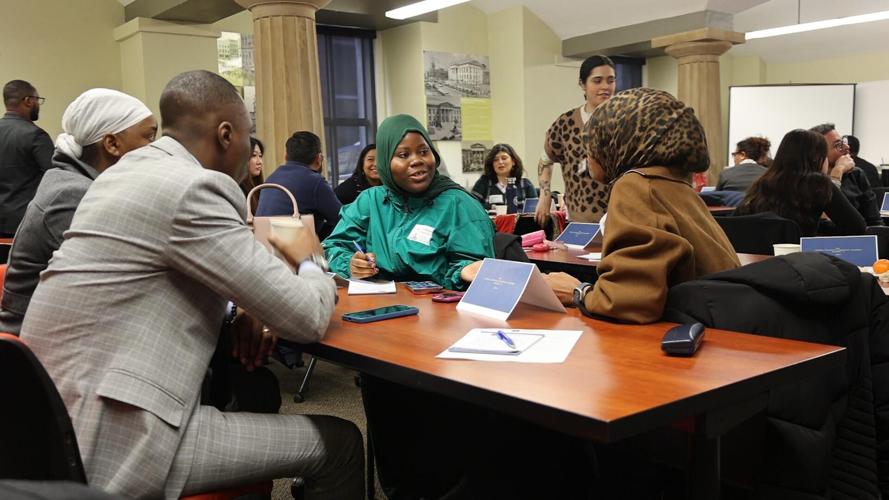 Global Leadership Academy Cohort talks at table.JPG