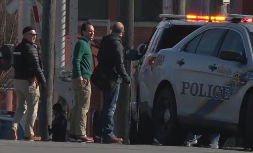 Louisville mayoral candidate Craig Greenberg speaks with police after shots fired at his office on Feb. 14, 2022