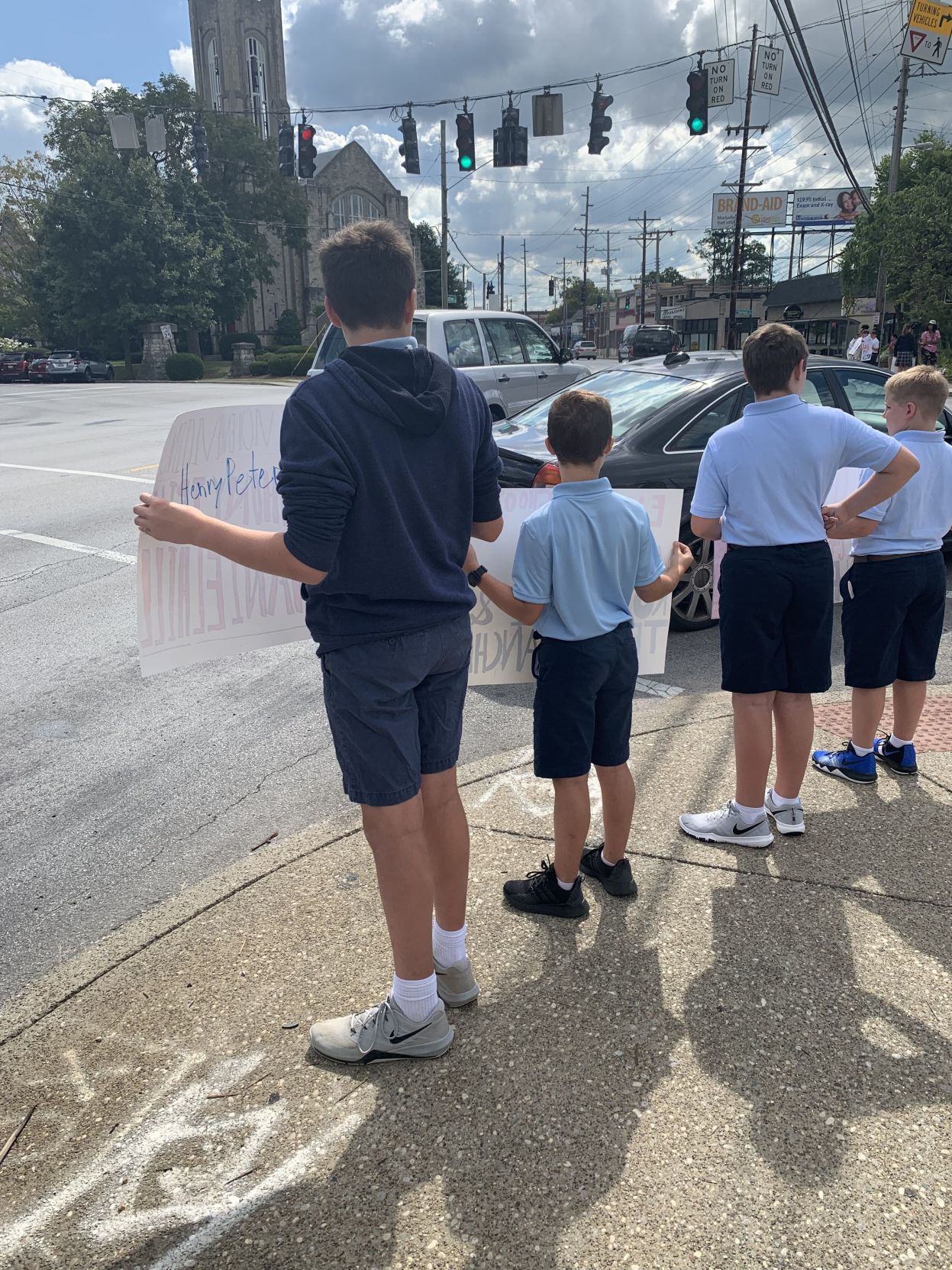 Saint Francis of Assisi stand on Douglass Loop for anti-violence walk