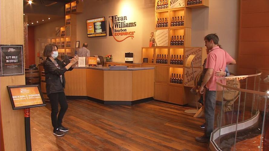 People pose for a photo at the Evan Williams Bourbon Experience