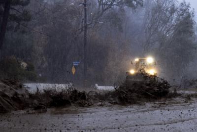 arafed tractor driving through a flooded road in the rain