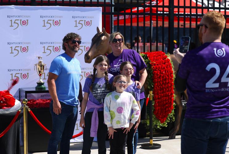 Family poses with Kentucky Derby trophy