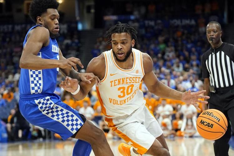 Tennessee guard Josiah Jordan James dirbbles off his foot.jpeg