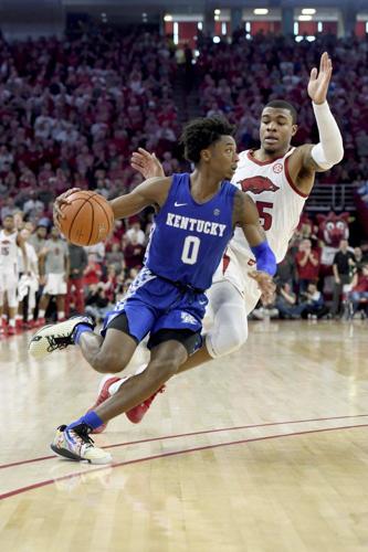 Kentucky guard Ashton Hagans (0) drives past Arkansas defender Reggie Chaney