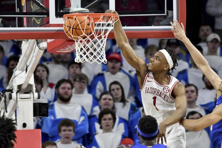 Arkansas guard JD Notae dunks the ball over Kentucky defenders.jpeg