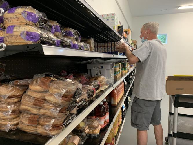 Workers restock shelves after break-in