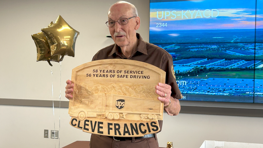 Cleveland 'Cleve Francis' poses with retirement plaque