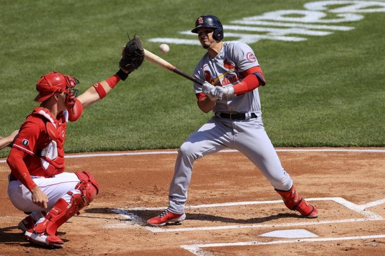 Cincinnati Reds' Tyler Stephenson, left, catches the ball as St. Louis Cardinals' Nolan Arenado reacts to the pitch