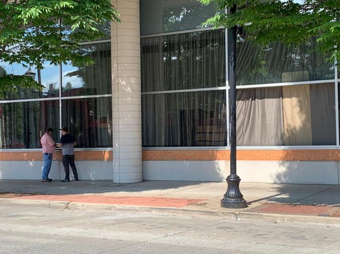 LMPD Protests - Workers examine damaged windows at Marriott