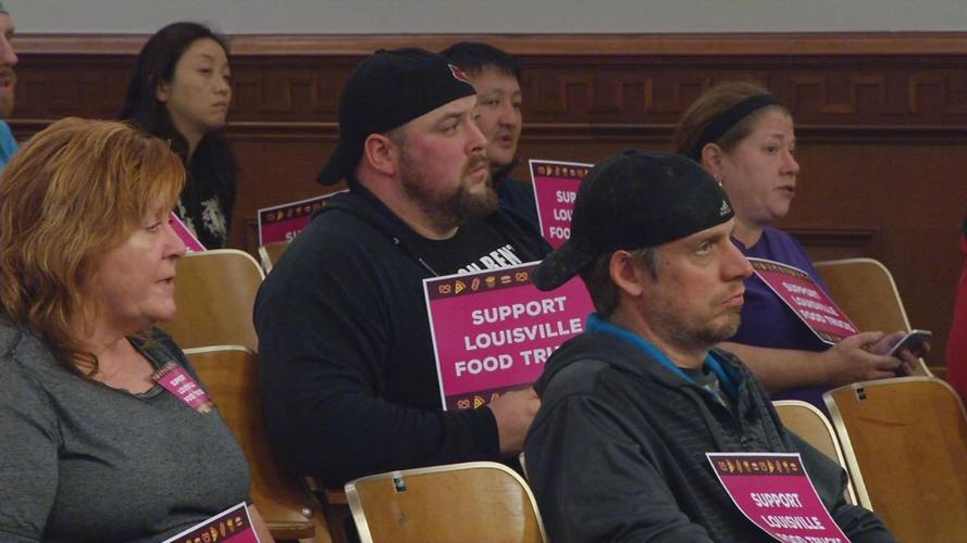 Supporters of food truck businesses brought signs to the June 4, 2019 Louisville Metro Council meeting