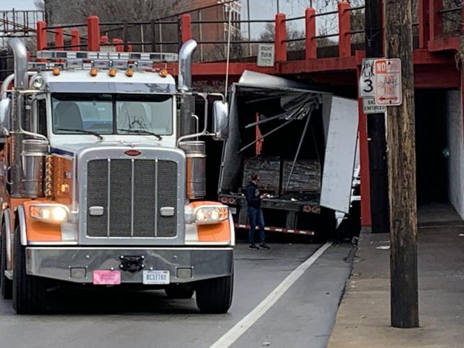 Truck stuck under overpass