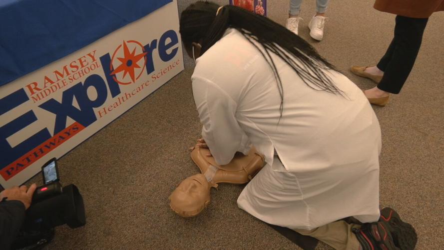 Med student practices CPR on mannequin