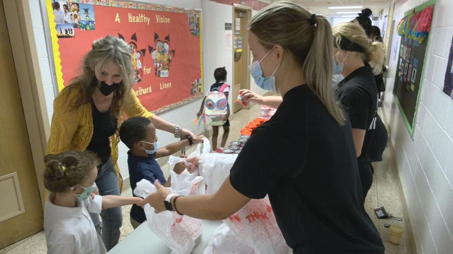 Blessings in a Backpack volunteers hand out much-needed food to students at Engelhard Elementary School