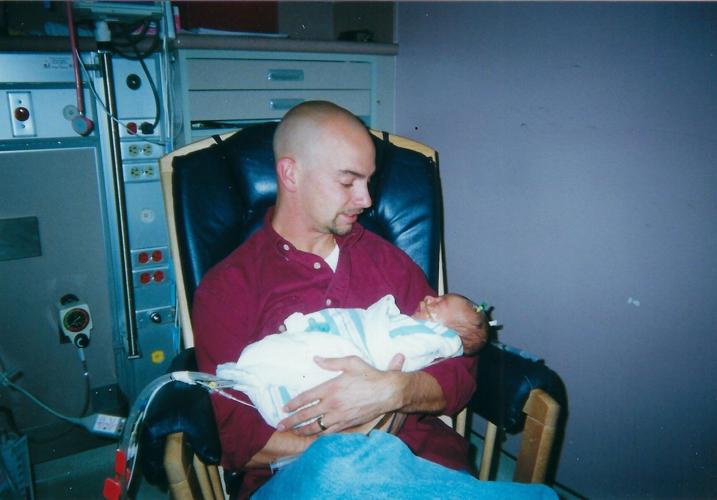 Rice holds newborn son inside hospital