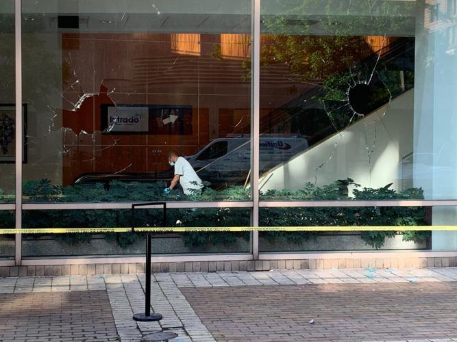 LMPD Protests - Worker cleans up inside Fifth Third Bank with shattered windows