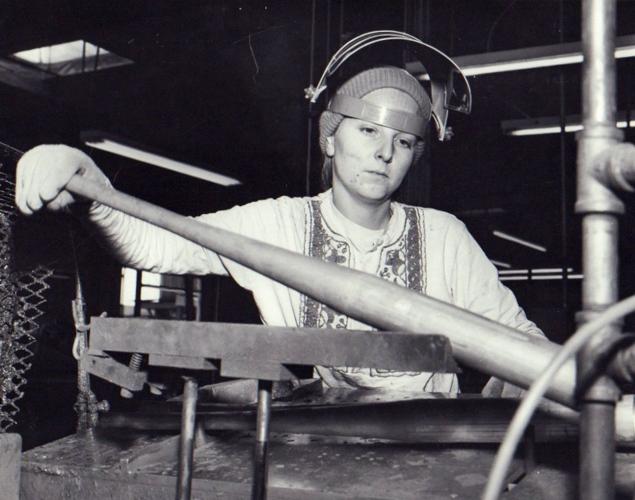 Unidentified Hillerich & Bradsby Co. employee manufacturing a metal bat