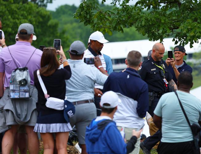 Fans watch Tiger Woods walk by.JPG