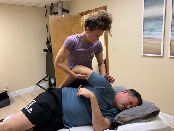 Elizabeth Elliott helps Keith Kaiser stretch