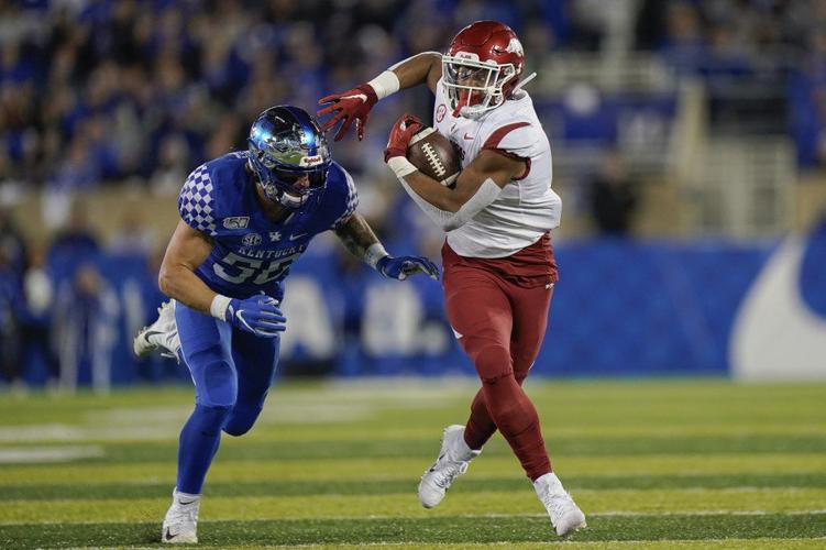 Arkansas running back Rakeem Boyd, right, is chased down by Kentucky linebacker Kash Daniel
