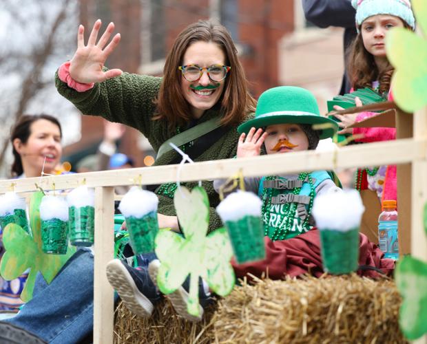 Woman and girl wave to crowd at St. Patrick's Day Parade.JPG