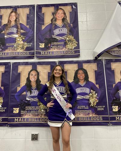 Addison Colvin with cheerleading poster.JPEG