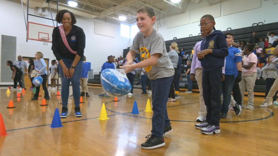 Carter Traditional Elementary students roll frozen turkeys at bowling pins - 11.17.23