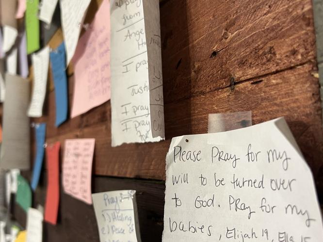 Prayer request messages line the walls