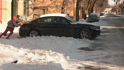 NEIGHBORHOOD ROADS SNOW  - PUSHING A CAR OUT 1-27-2026.jpeg