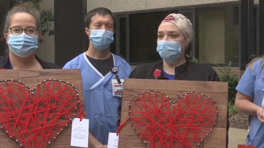 U of L Health workers pose with string art creations made by Megan Chelliah