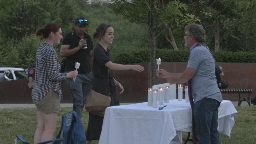 People receive candles for Prayer Vigil at Big Four Bridge.jpeg
