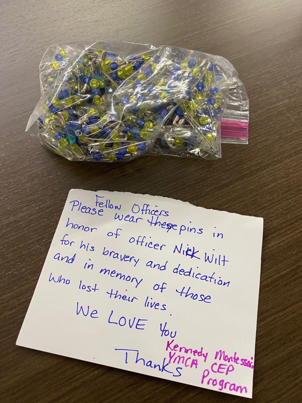 Custom made pins to honor Officer Nick Wilt given to LMPD by JCPS students.