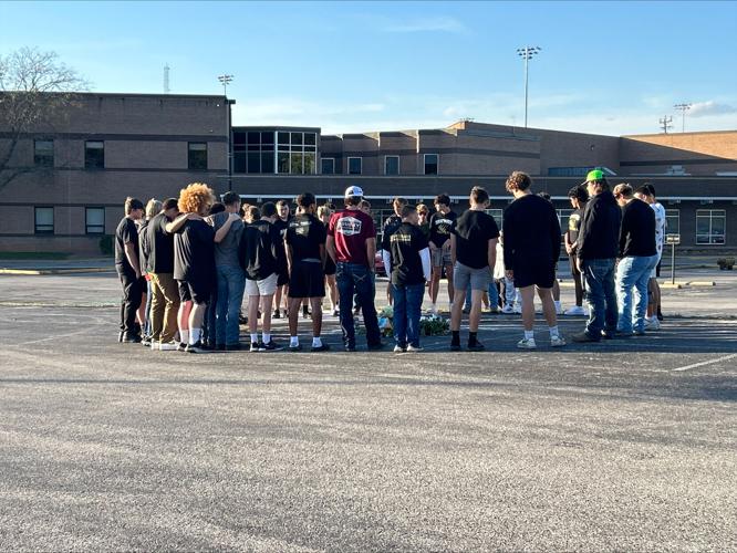 People stand in a vigil for Bryce Gerlach, after he was killed at Harvest Homecoming