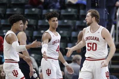 Indiana's Joey Brunk (50) is congratulated by Justin Smith (3) and Trayce Jackson-Davis