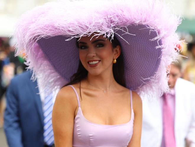 Woman wears pastel hat at Churchill Downs.JPG