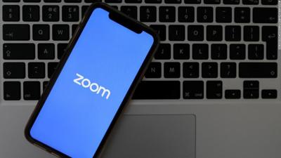 Cell phone with Zoom logo on computer keyboard