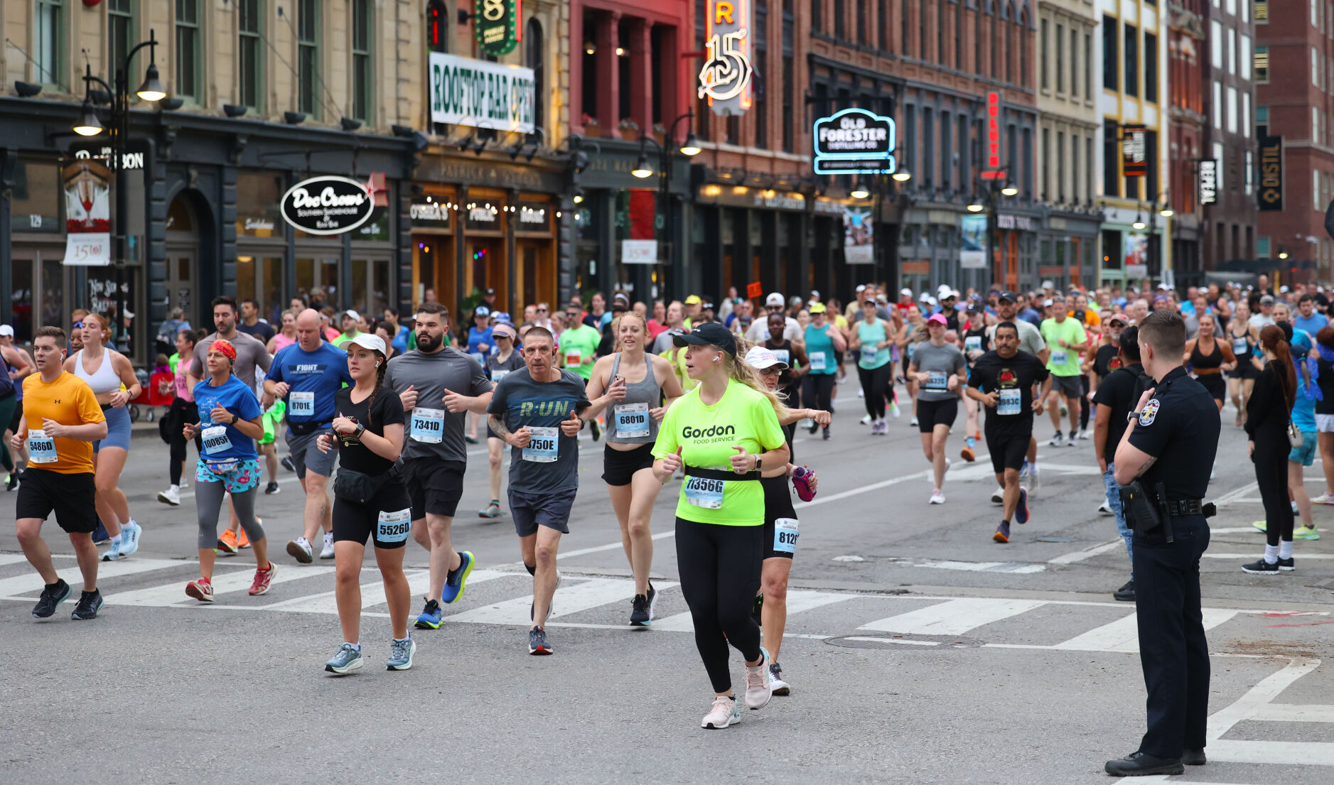 People run past Whiskey Row.JPG