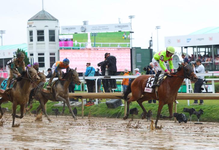 Horses run on muddy Oaks Day.JPG