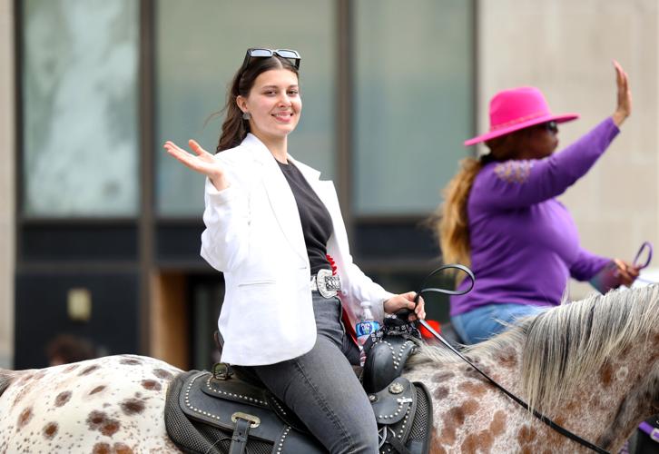 Woman waves in the Pegasus parade.JPG
