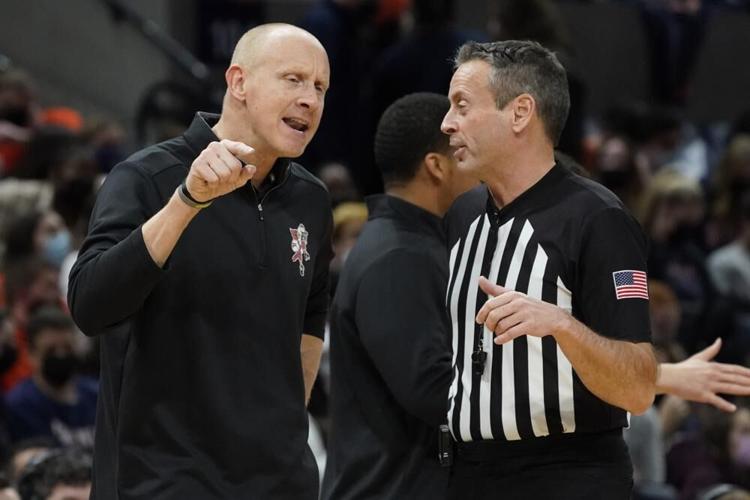 Louisville head coach Chris Mack argues with a ref during game against Virginia.jpeg