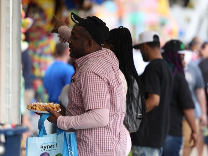 Man questions carnival worker at the Chow Wagon