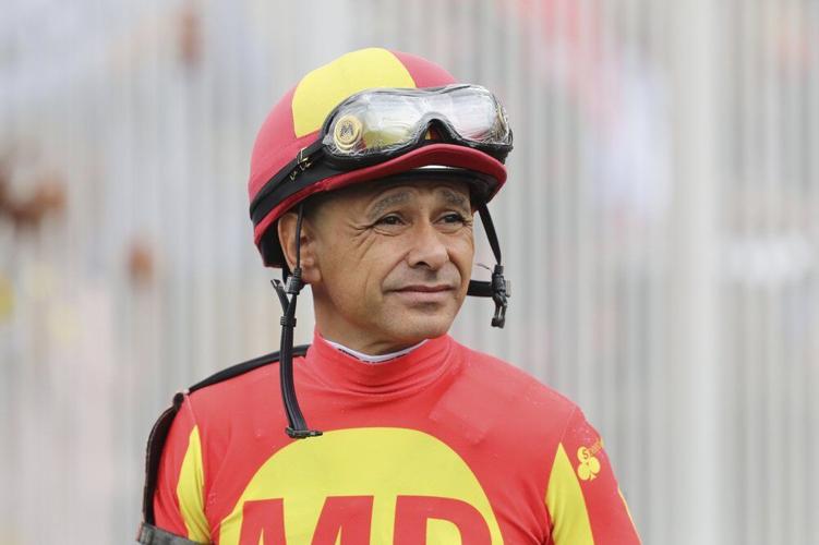 Jockey Mike Smith looks on before a horse race at Churchill Downs