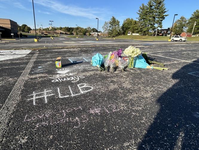 Flowers at Bryce Gerlach's parking spot after he was shot and killed at Harvest Homecoming
